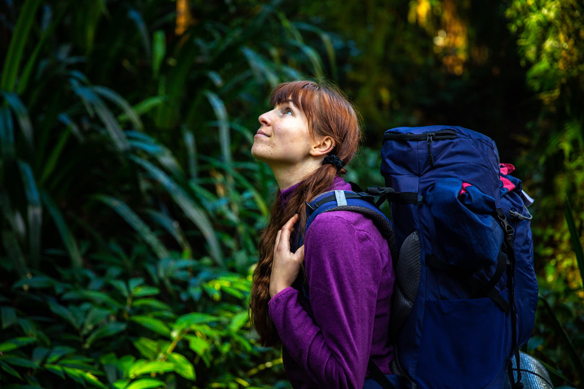 Hiker with a large backpack in the rainforest of Lamington National Park, Queensland