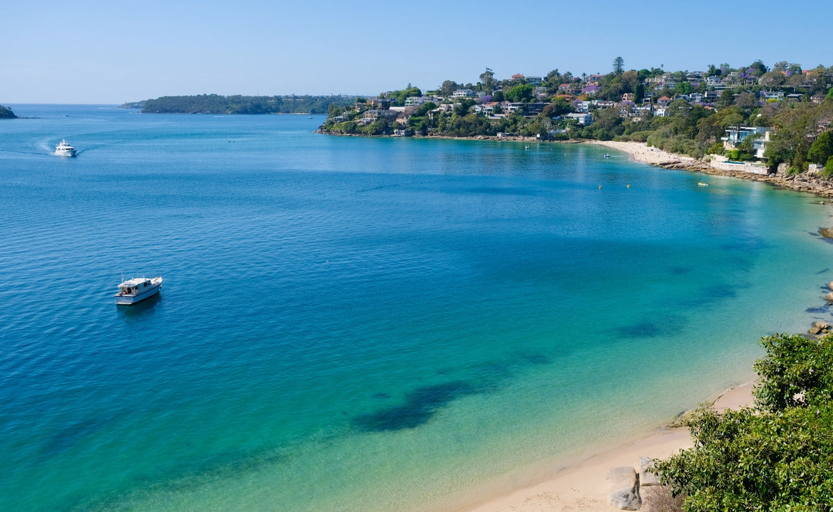 Chinamans Beach curving along clear turquoise Middle Harbour, Mosman, Sydney