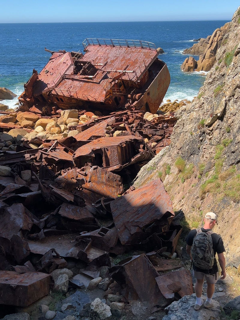 Rusted shipwreck below Mayon Cliff near Land's End, Cornwall, UK