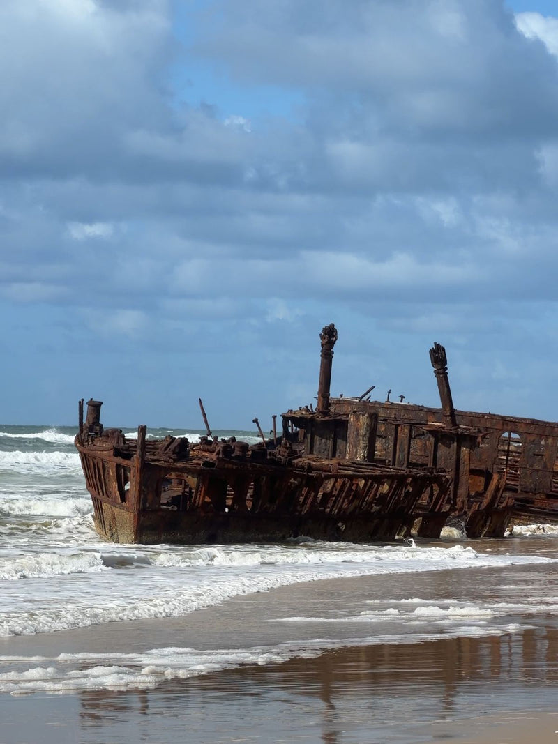 Rusting wreck of the SS Maheno in the surf on K'gari, Queensland, Australia